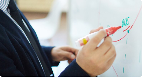 Image of a man writing to the writing board